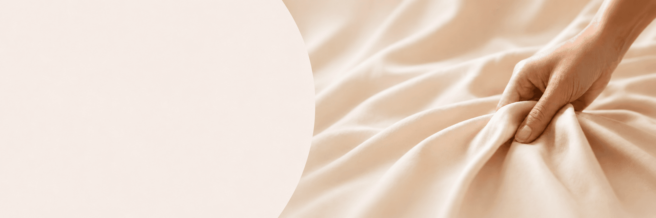 Hand gently holding soft cream viscose fabric